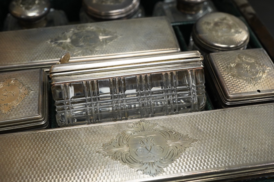 A Victorian brass mounted coromandel wood travelling toilet box, containing nine engine turned silver mounted cut glass toilet jars, with engraved initial, Brownett & Rose, London, 1870, the box of square form, with inse